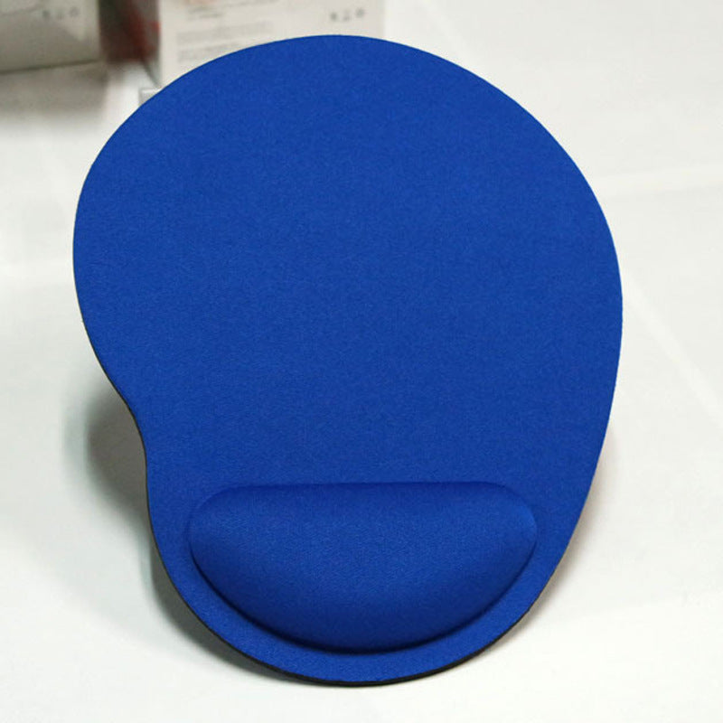 Pink wrist support pad on computer setup
