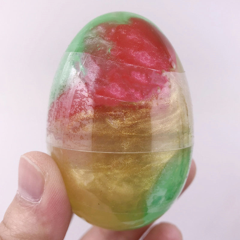 Hands playing with colourful Galaxy Egg Crystal Slime
