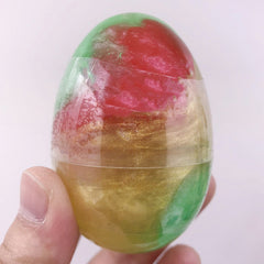 Hands playing with colourful Galaxy Egg Crystal Slime
