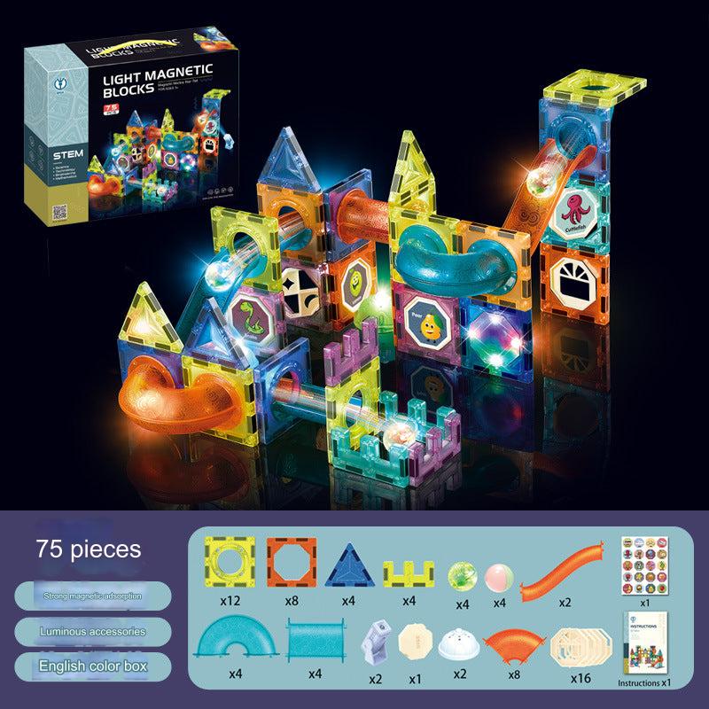 Child playing with magnetic blocks building structures