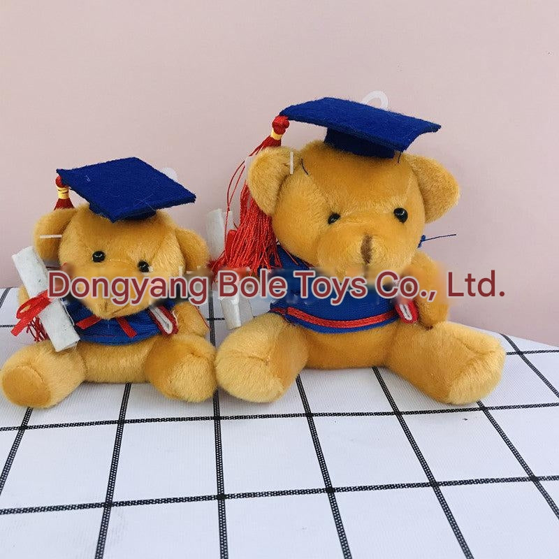 Gift bear holding graduation cap