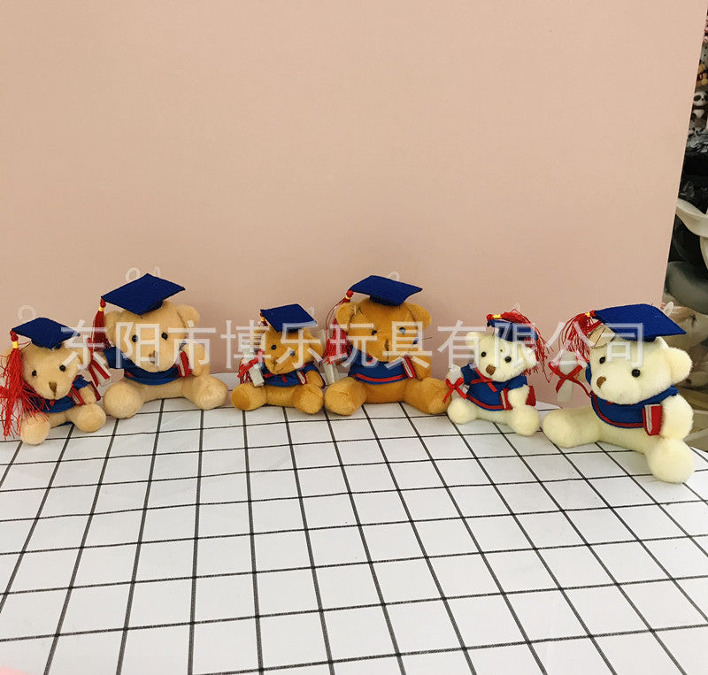 Dark brown plush bear with graduation cap