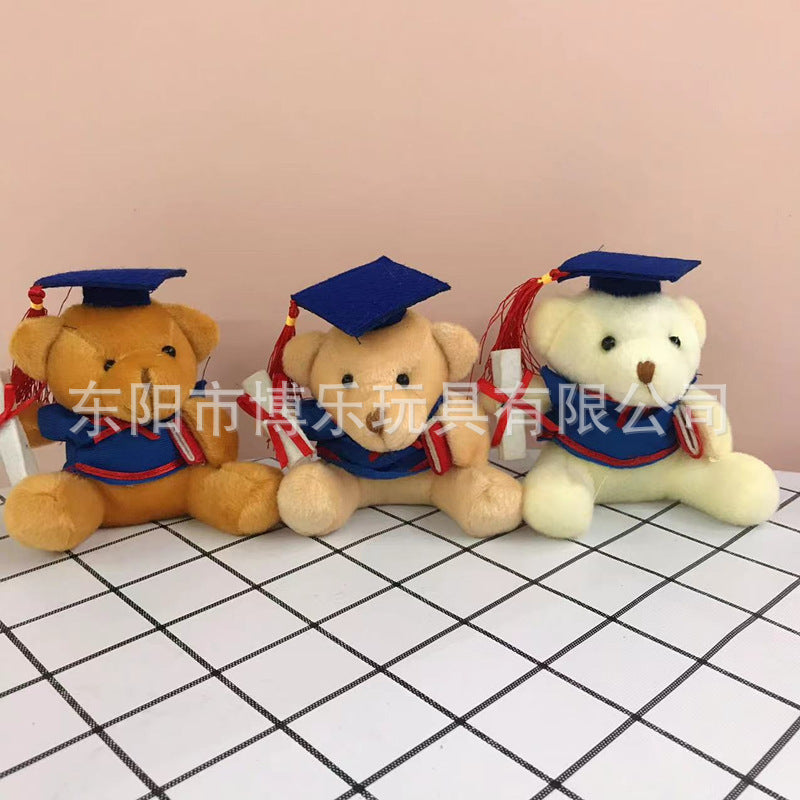 Plush bear surrounded by graduation items