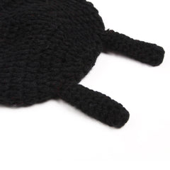Close-up of beetle-themed crochet baby hat