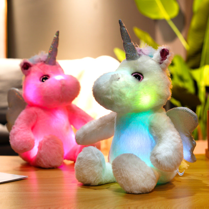 Glowing Unicorn Plush Toy on bed