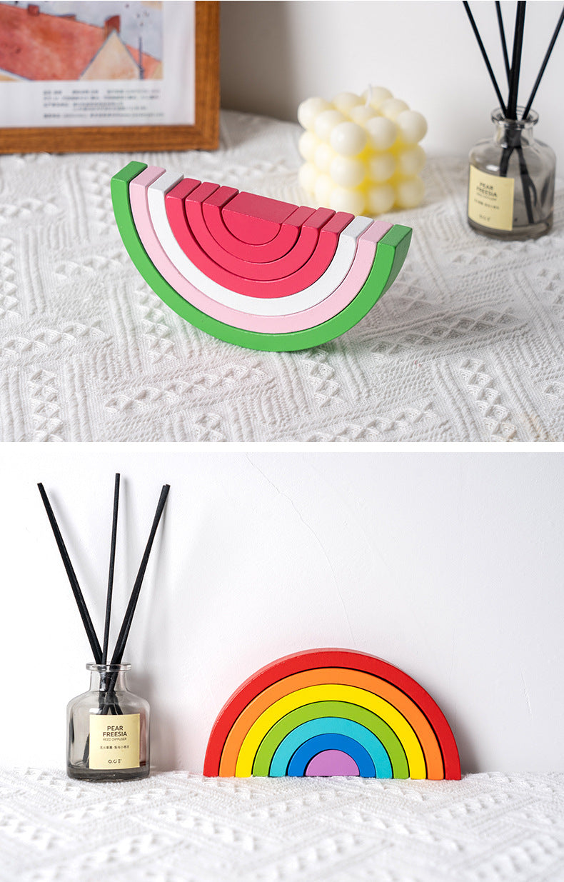 Person demonstrating a stacking challenge with rainbow toy