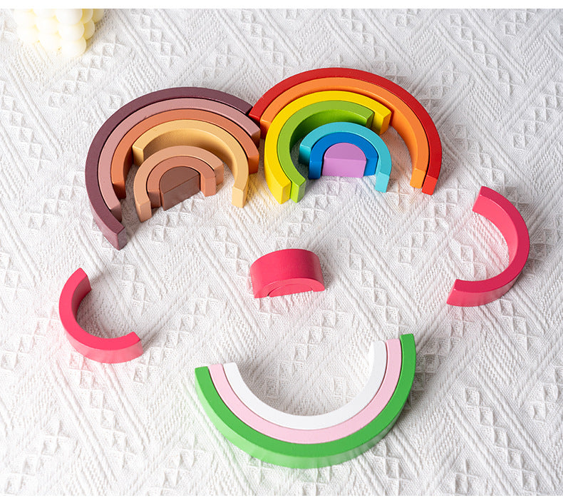 Toddler playing with rainbow stacker toy