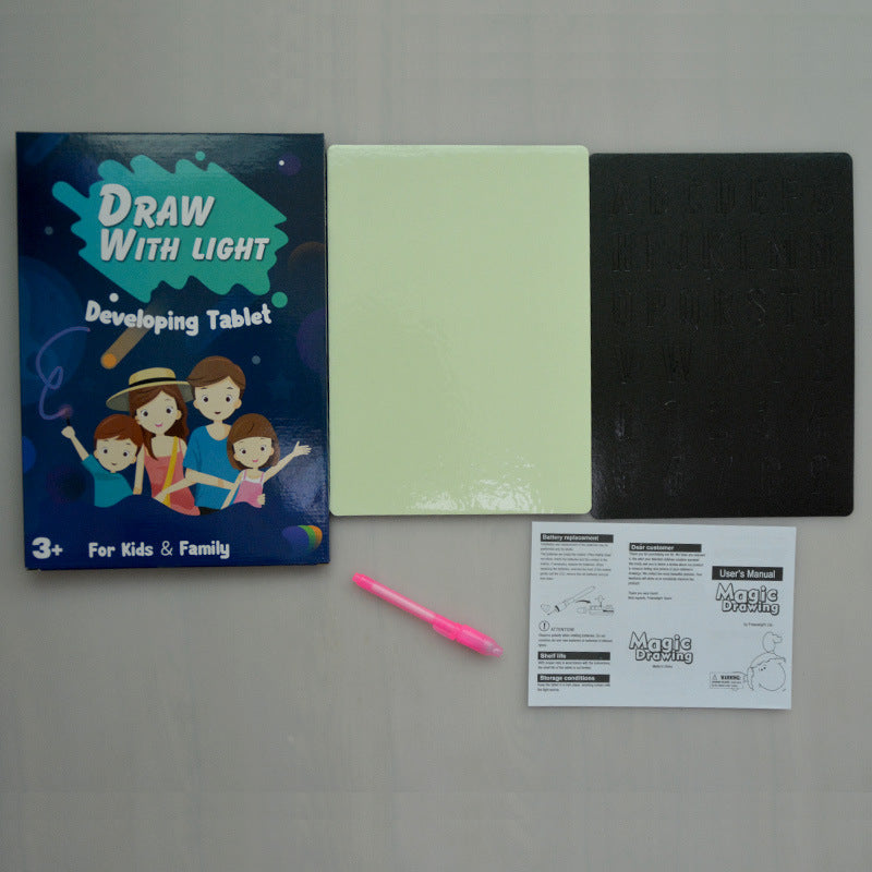 Kids using the glow drawing board with colourful pens