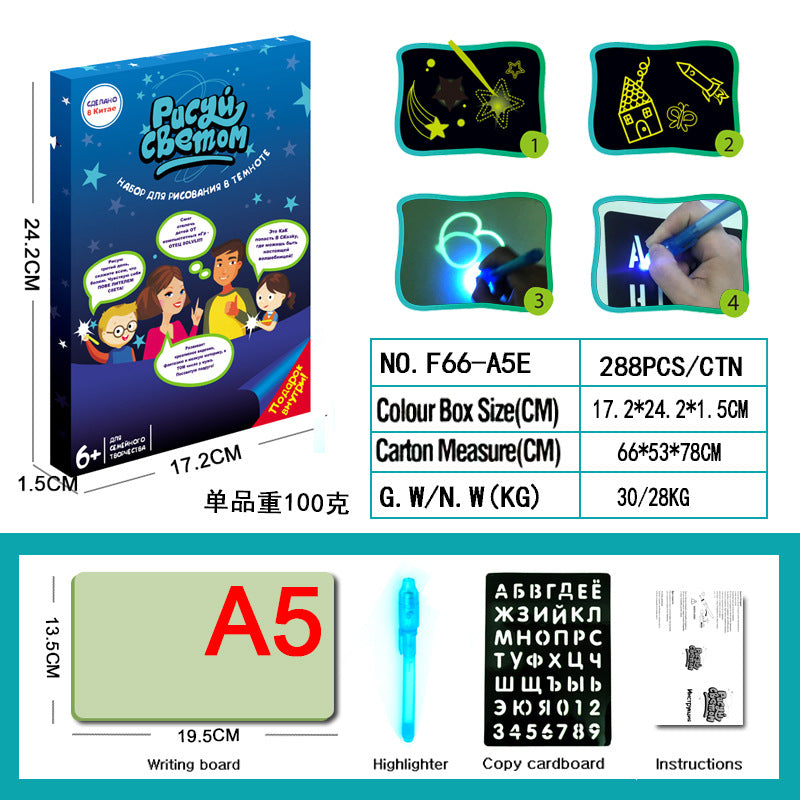 Child drawing on the glow pad in a dark environment