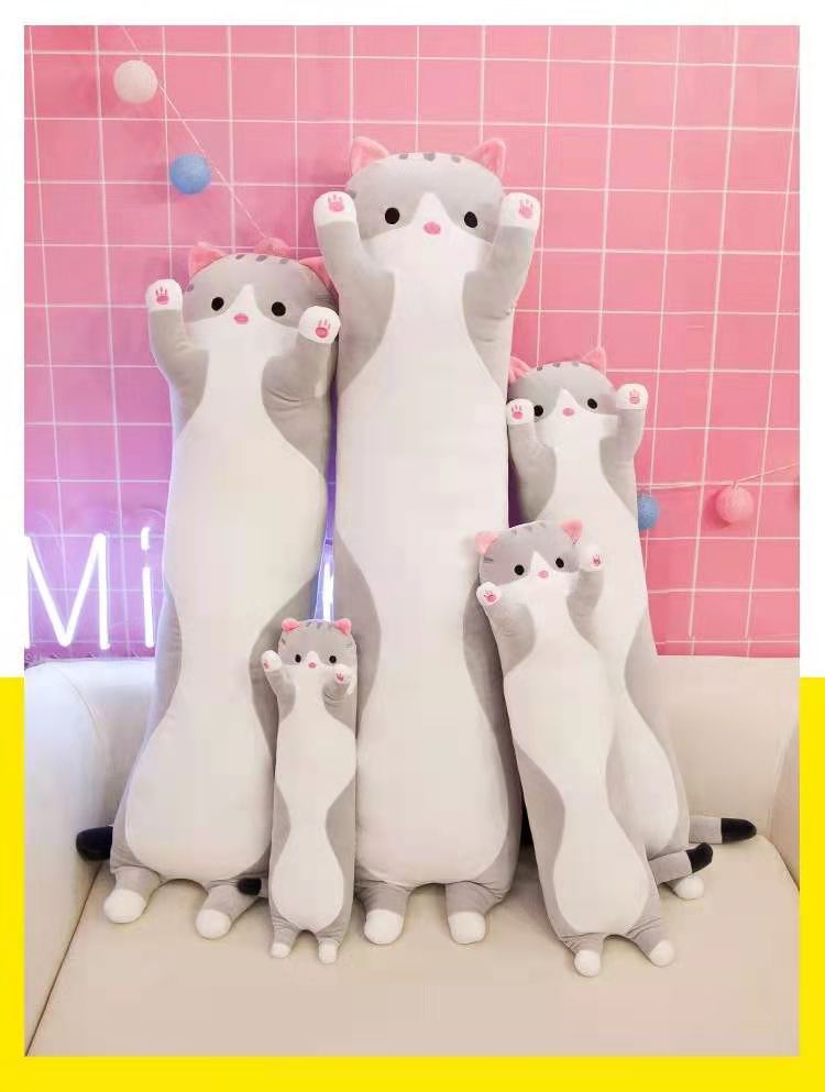 Plush cat pillow in a cozy setting