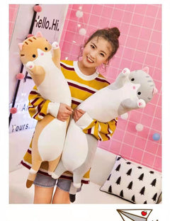 Soft plush cat pillow on a bed