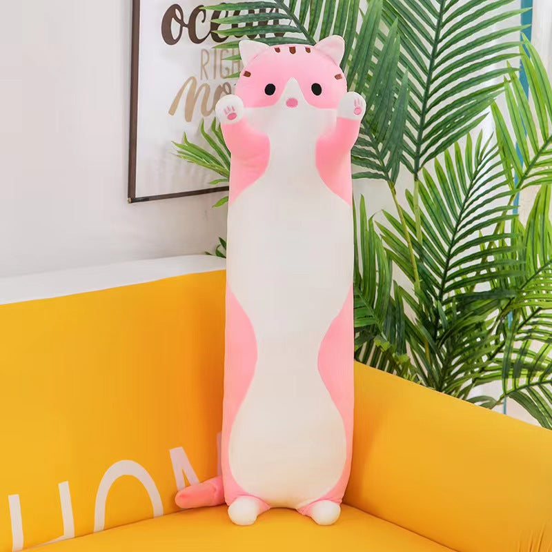 Soft plush cat pillow on a bed