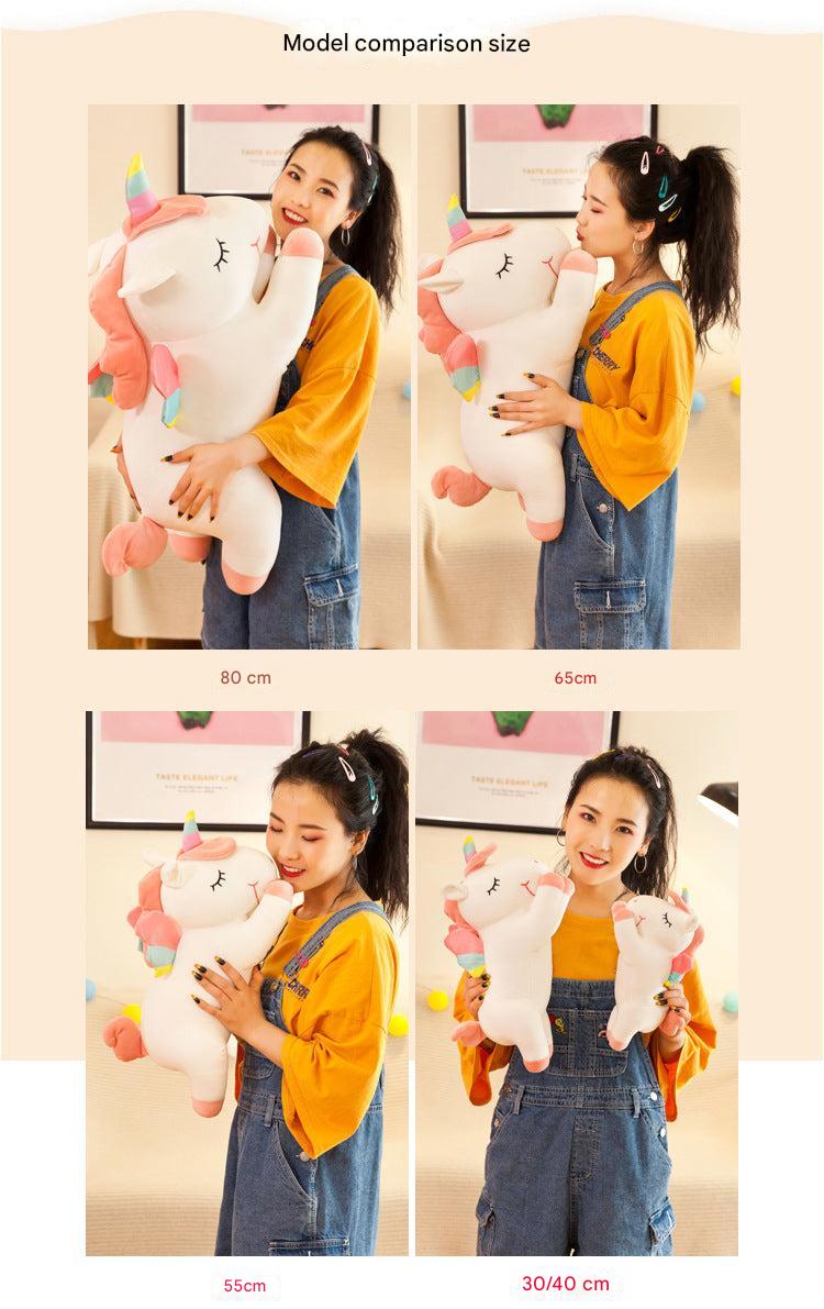 Angel Unicorn Plush Toy sitting on a soft surface