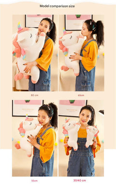 Angel Unicorn Plush Toy sitting on a soft surface