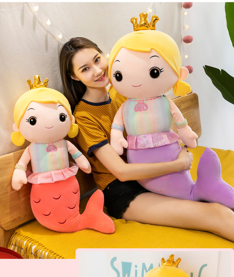 Mermaid pillow doll on colorful bedding