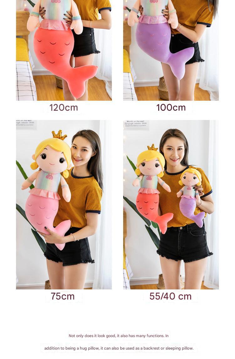 Child hugging the plush mermaid doll