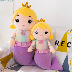 Child hugging the plush mermaid doll