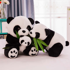 Realistic plush panda on bed
