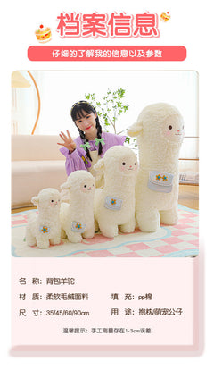 alpaca plush toy laid on grass