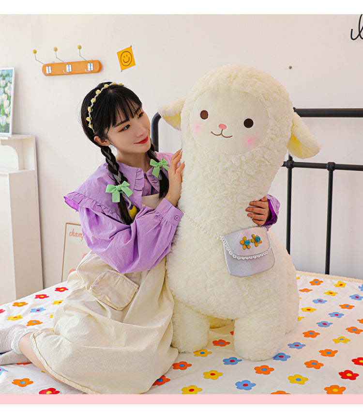 alpaca toy cuddled by child