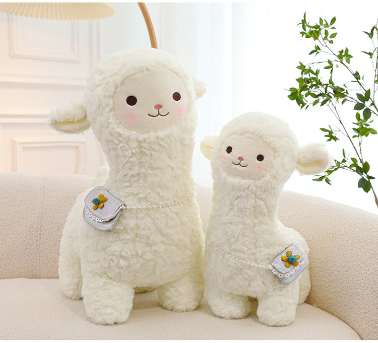 smiling alpaca toy with children
