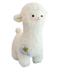 alpaca plush toy laid on grass