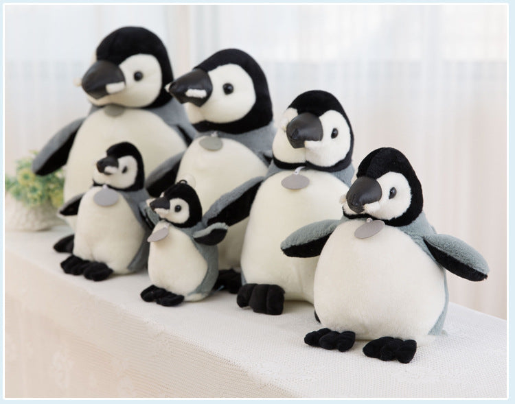 Group of children's plush toys including penguin