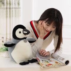 Child playing with Cartoon Penguin Doll