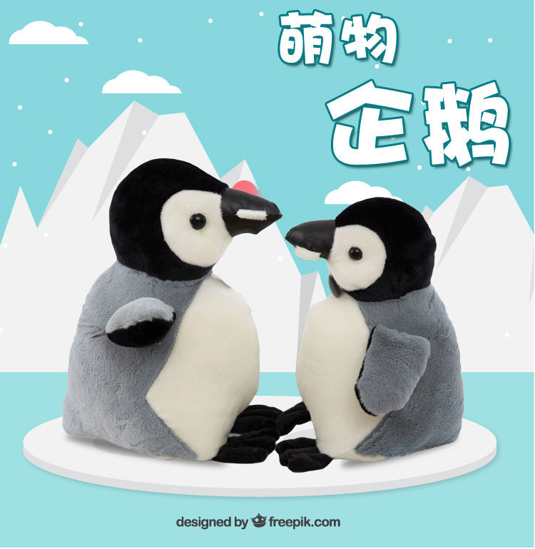 Penguin Doll on a bed with toys