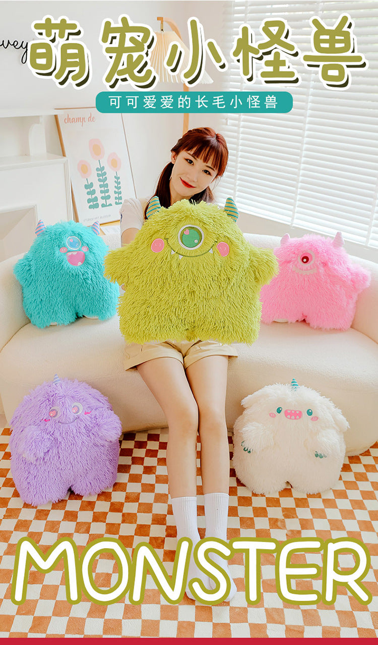 Image of cute monster plush pillow in a playful pose