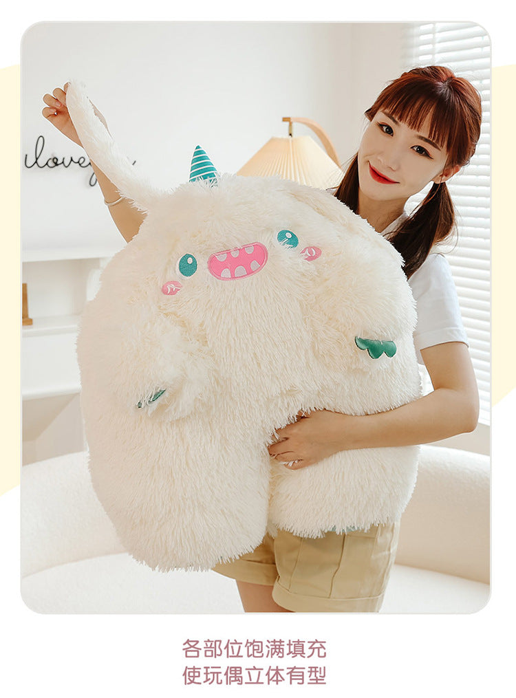 Close-up of cute monster pillow highlighting the plush material