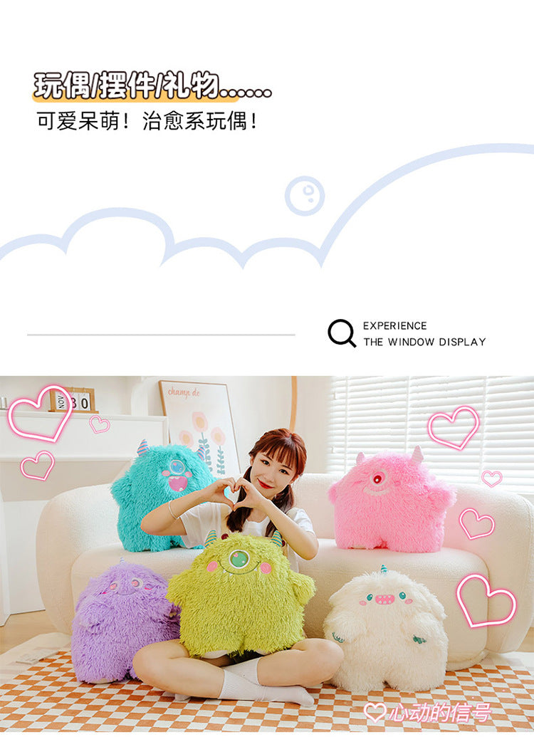 Cute monster pillow in a home setting