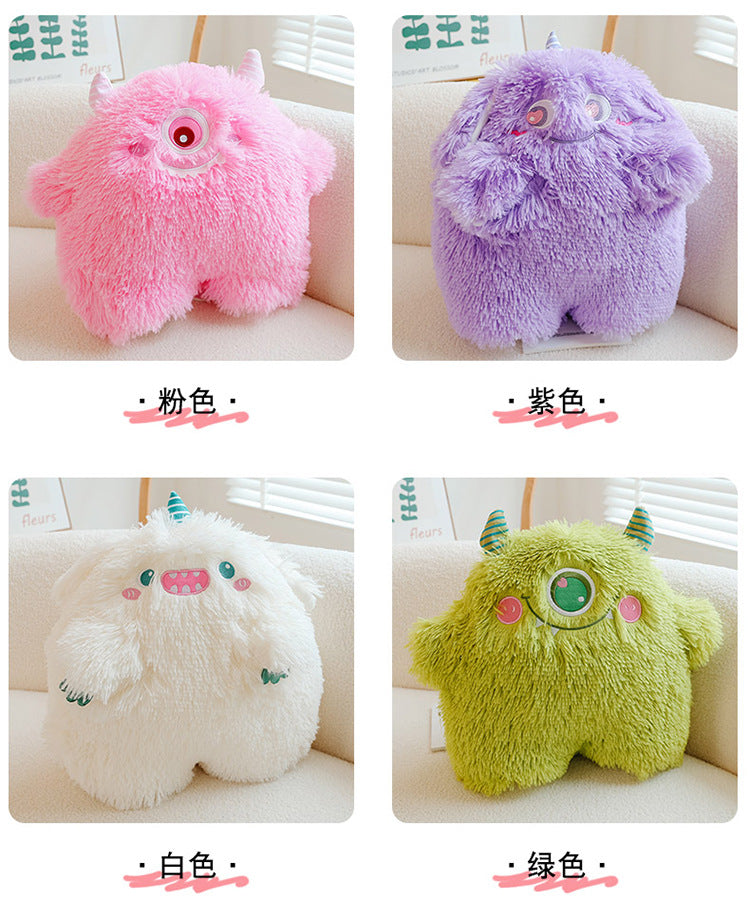 Playful and fun monster plush pillow displayed on a sofa