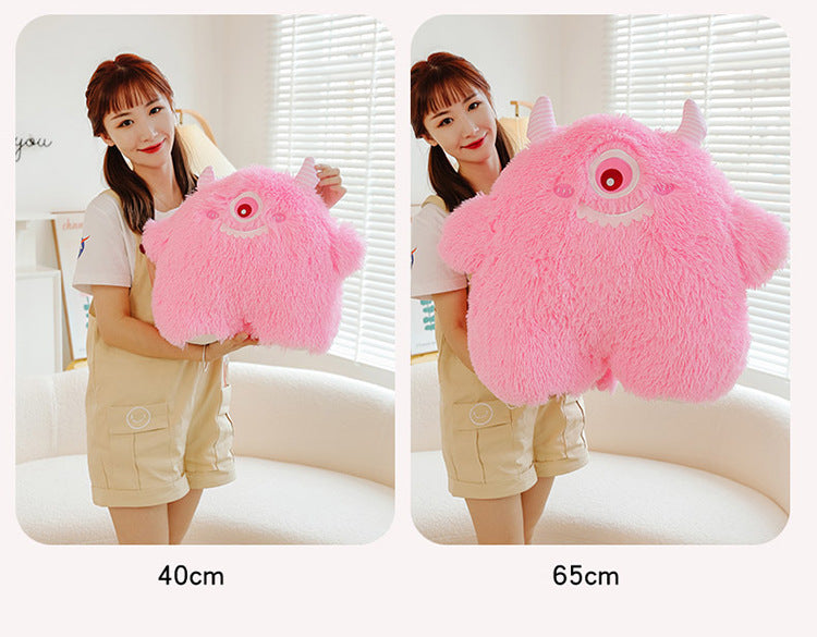 Cute monster plush pillow showing soft texture and charm