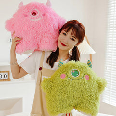 Adorable monster plush pillow on a bed showcasing its design
