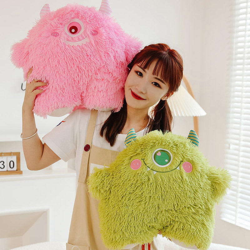 Adorable monster plush pillow on a bed showcasing its design