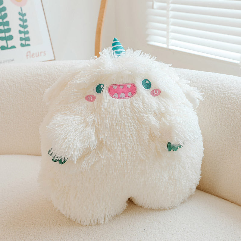 Cute monster pillow in a home setting