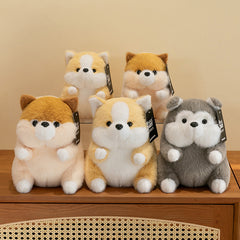 Corgi plush toy displayed on a couch