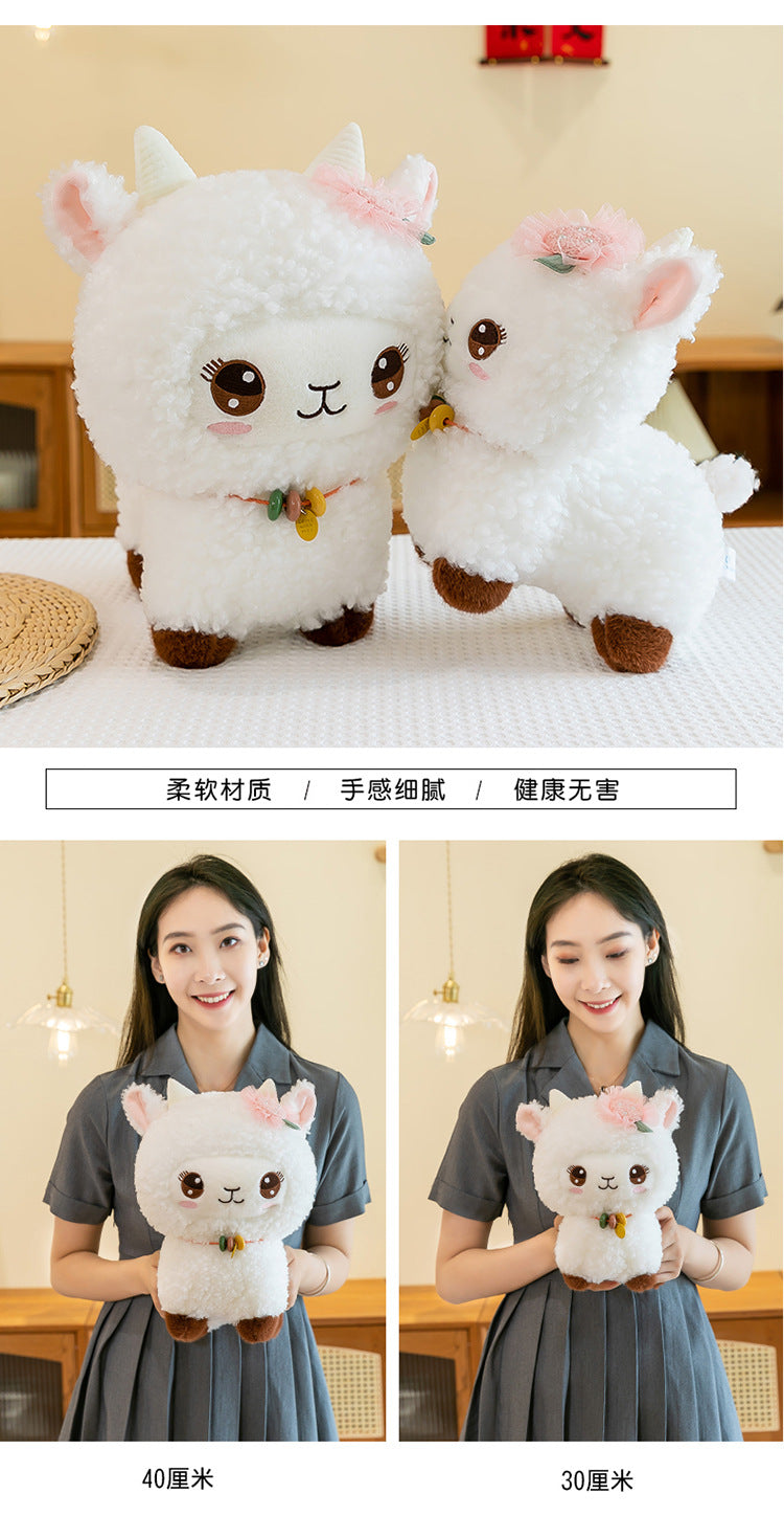 Smiling girl holding her sheep plush