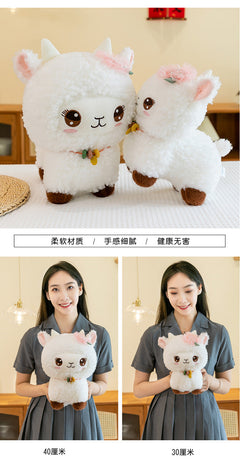 Smiling girl holding her sheep plush