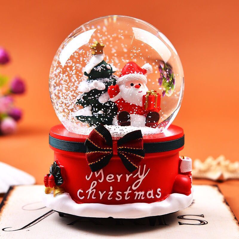 Full view of Christmas decoration snow globe with music