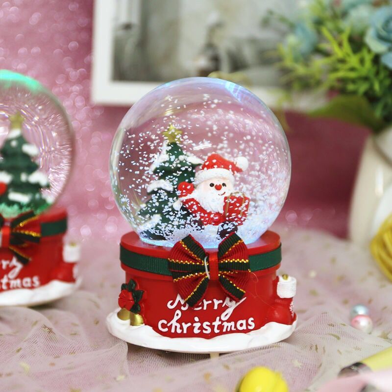 Close-up of musical snow globe showing automatic snowfall