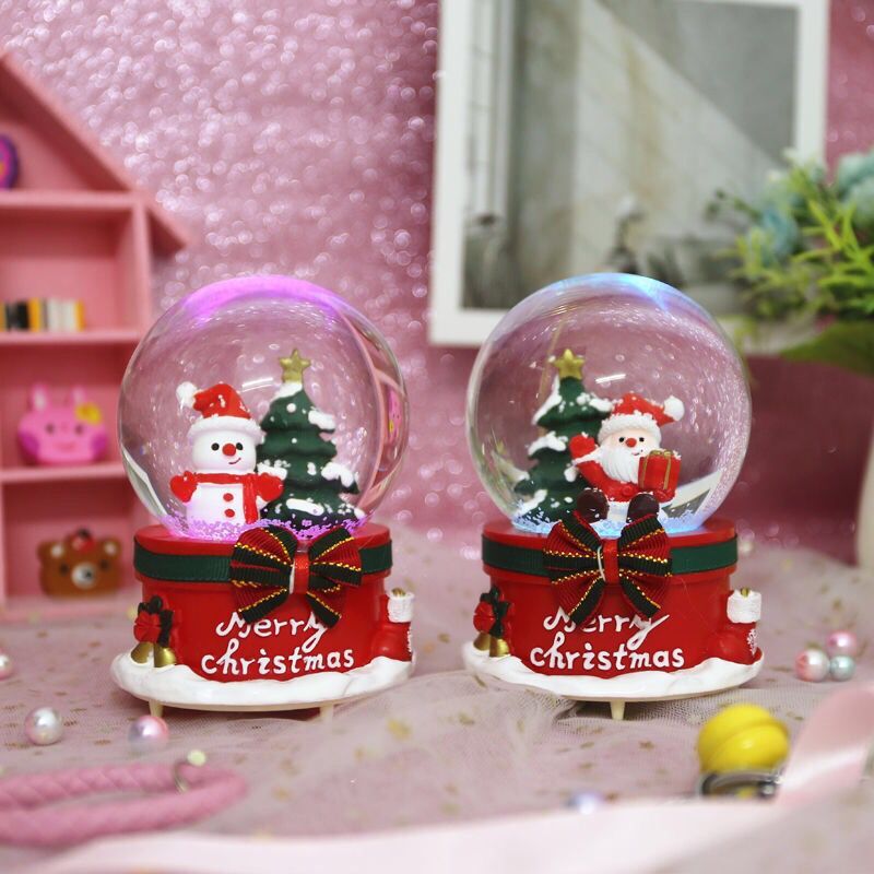 Beautifully lit Christmas snow globe at night