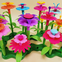 child assembling plastic garden blocks