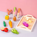 Child playing with magnetic wooden vegetable playset