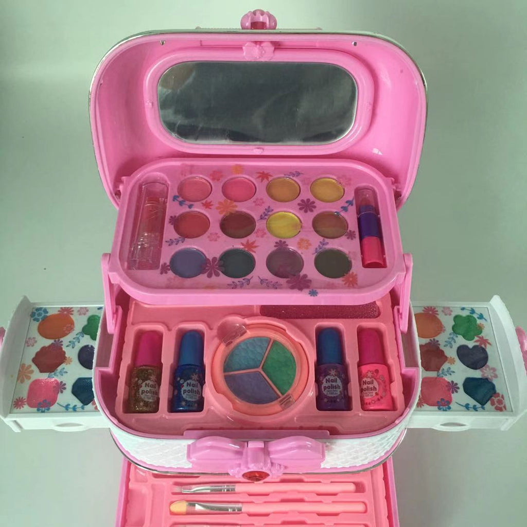 Child applying lipstick from kid's cosmetic set