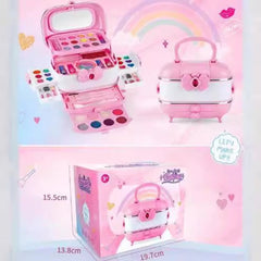 Child applying lipstick from kid's cosmetic set