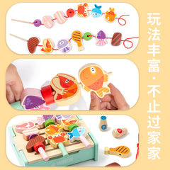 Child playing with wooden BBQ grill set