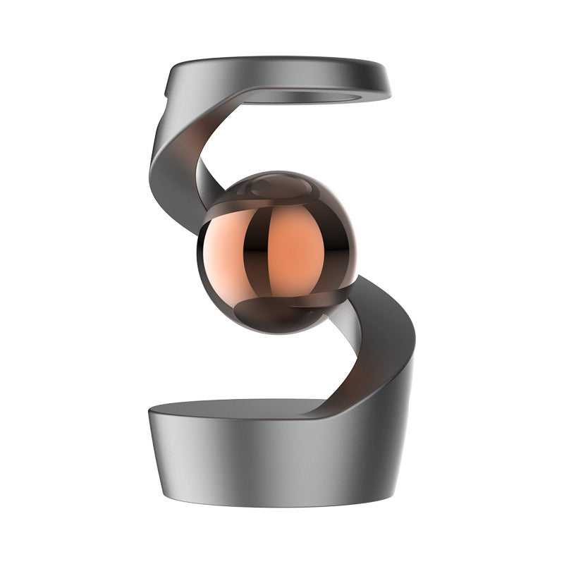 levitating metallic gyroscope on desk