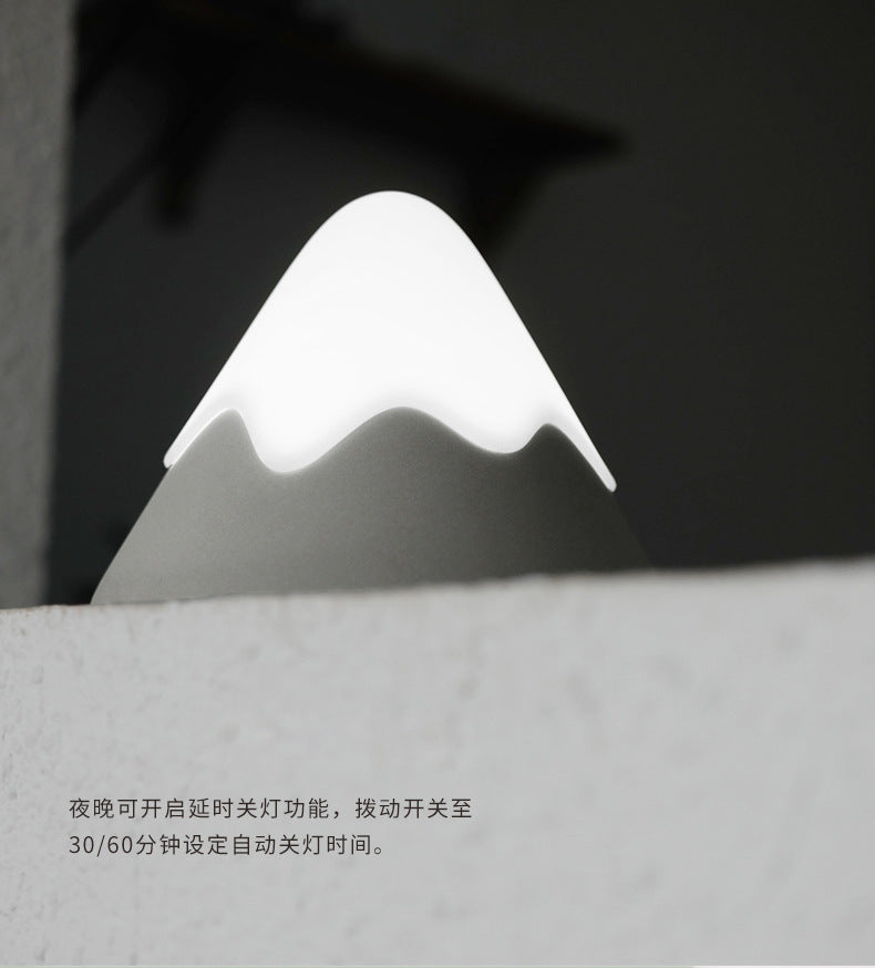Touch-activated mountain night light on dresser